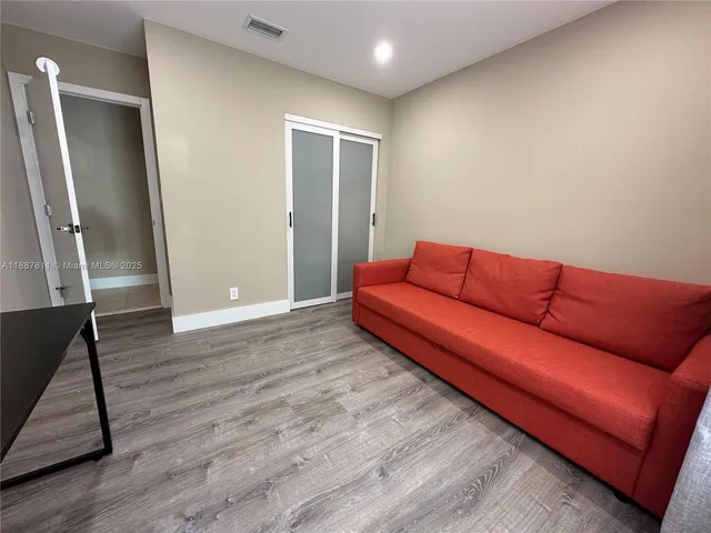 a blue couch sitting in a living room with a rug