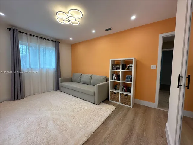 a spacious bedroom with a bed and a window