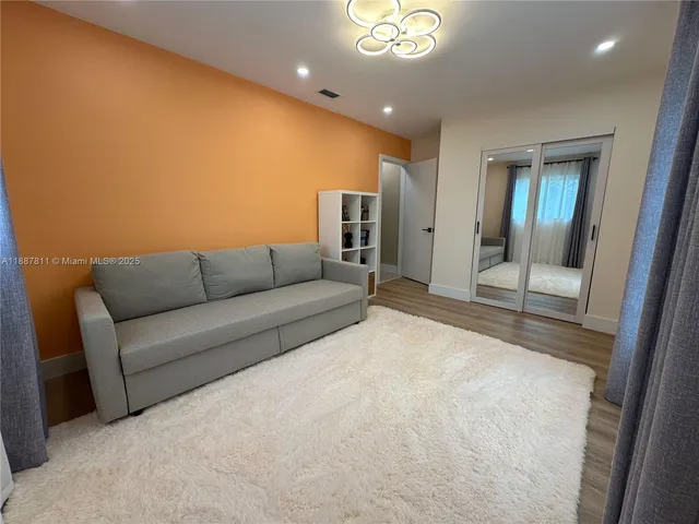 a living room with furniture and a glass door