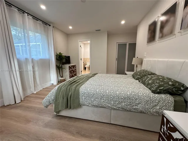 a bedroom with a large bed and a window