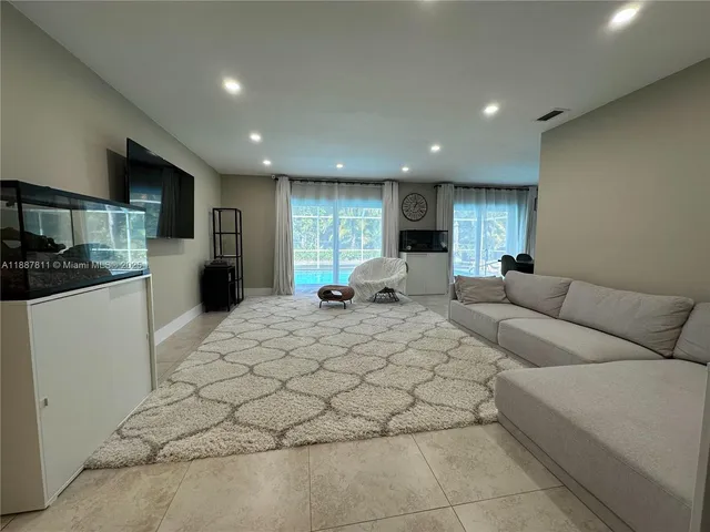 a large white kitchen with a large window