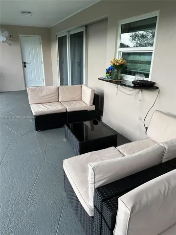 a view of yard with outdoor seating and trees