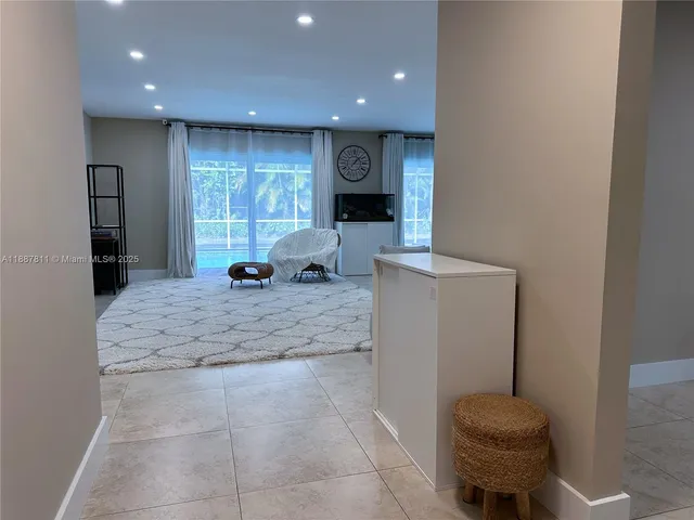 a large room with a large window and furniture