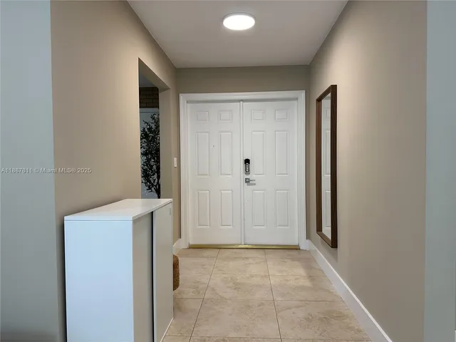 a view of a hallway to rooms