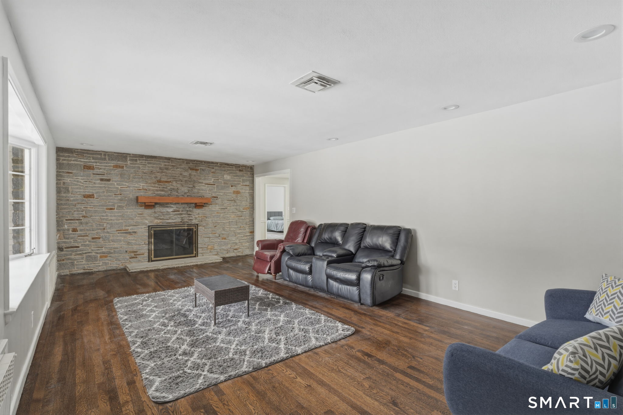 35 West Ridge Drive West Hartford, CT 06117 - Photo 12 of 38 a living room with furniture and a fireplace