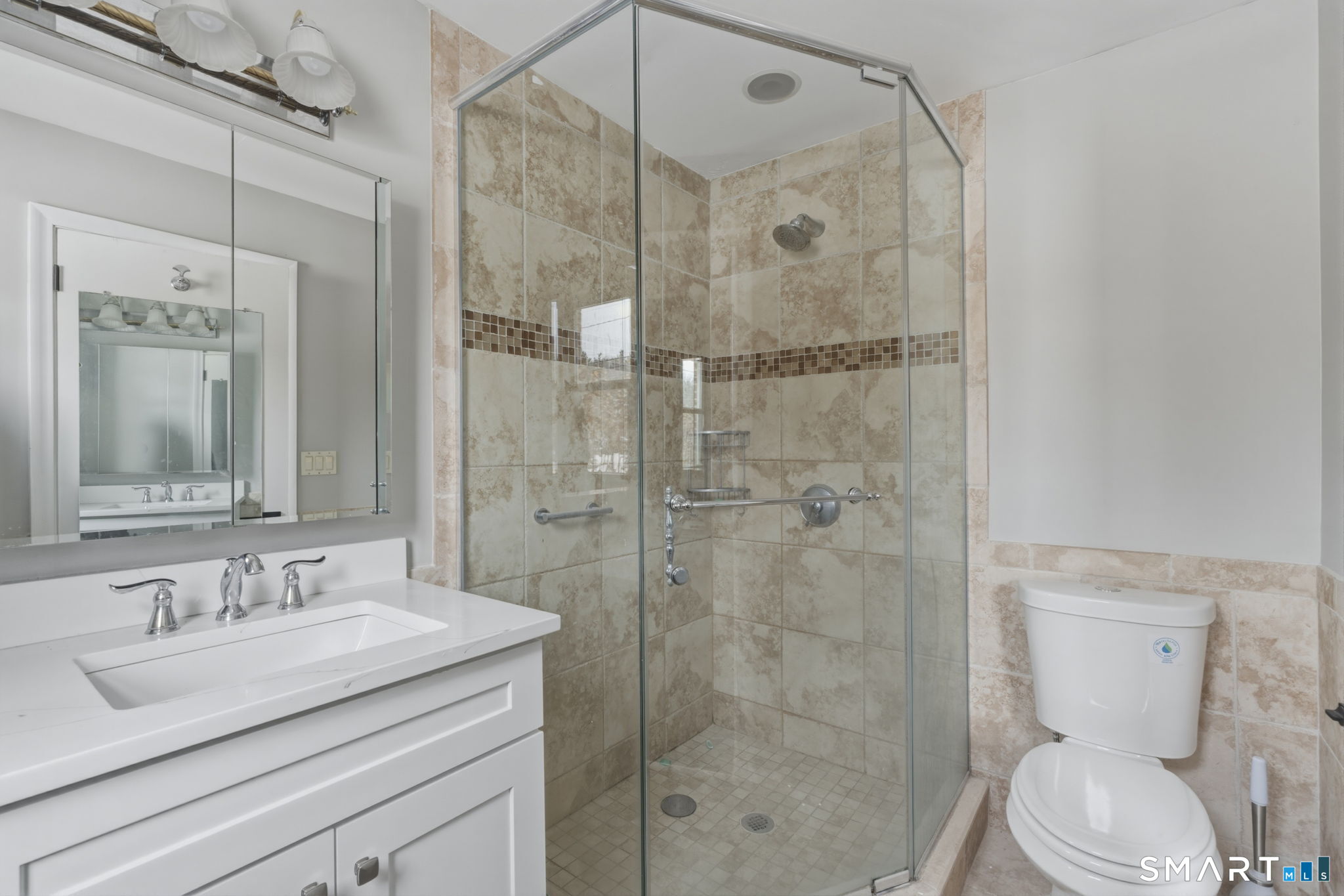 35 West Ridge Drive West Hartford, CT 06117 - Photo 25 of 38 a bathroom with a granite countertop sink toilet a mirror and shower
