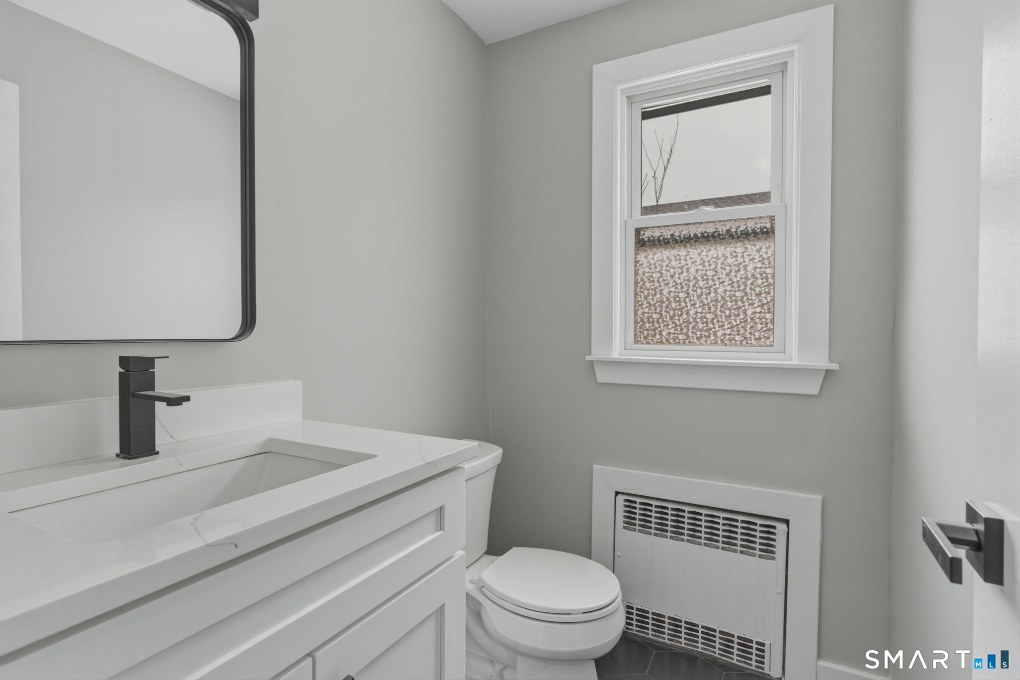 35 West Ridge Drive West Hartford, CT 06117 - Photo 26 of 38 a bathroom with a toilet sink vanity and mirror