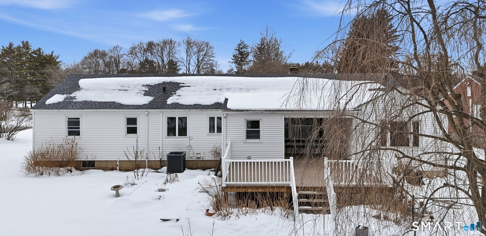35 West Ridge Drive West Hartford, CT 06117 - Photo 3 of 38 a view of a white house with a wooden fence