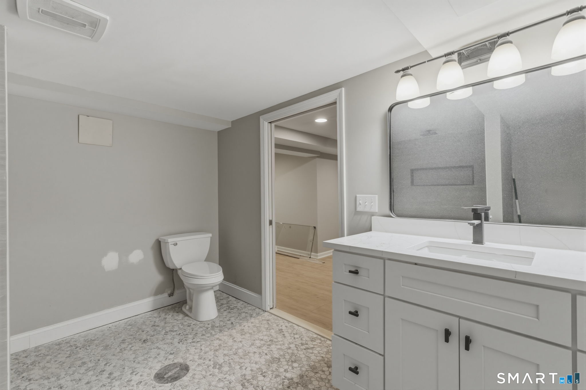 35 West Ridge Drive West Hartford, CT 06117 - Photo 32 of 38 a bathroom with a sink a toilet and a mirror