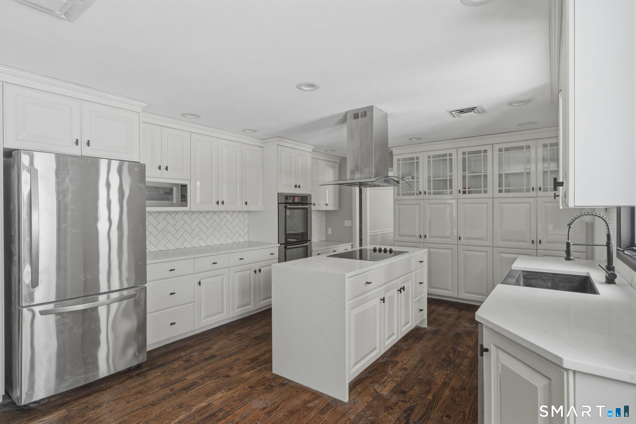 35 West Ridge Drive West Hartford, CT 06117 - Photo 9 of 38 a kitchen with white cabinets and refrigerator