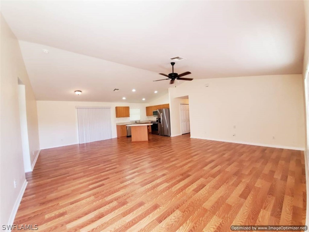 4652 27th Street Southwest Lehigh Acres, FL 33973 - Photo 4 of 21 a view of empty room with wooden floor and window