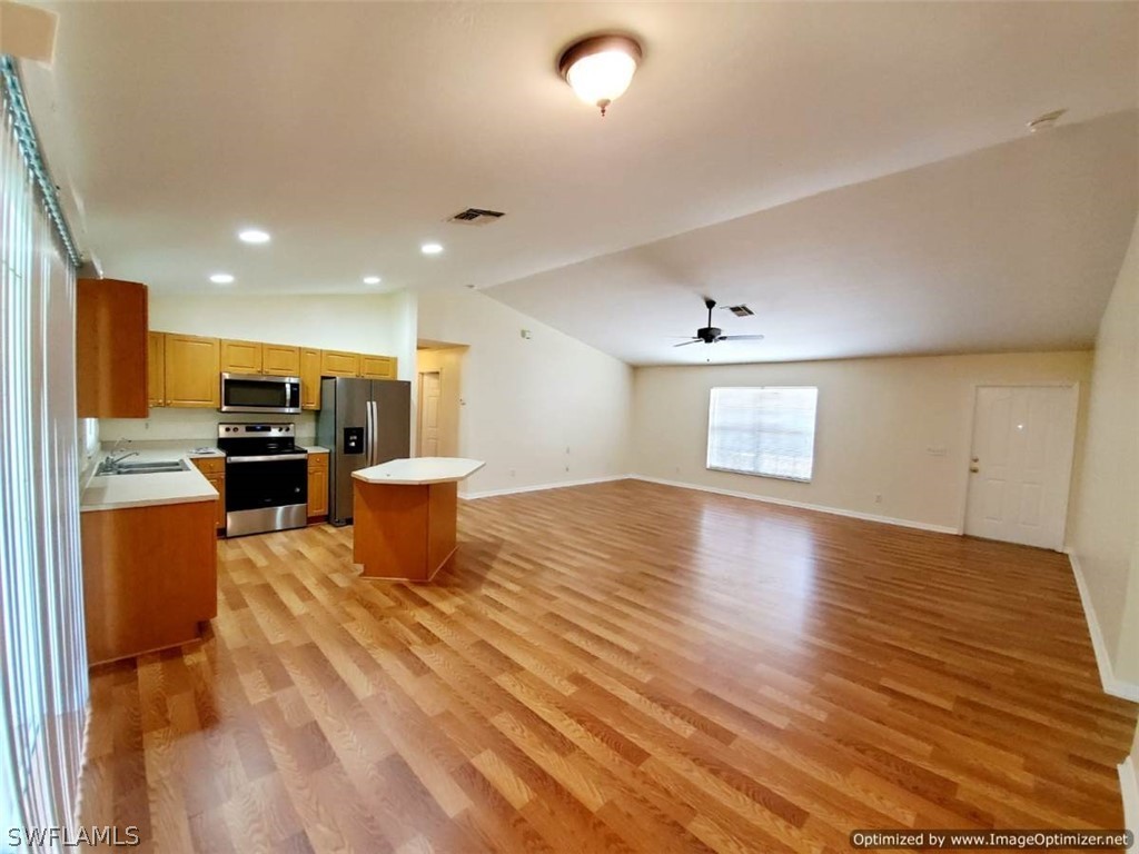 4652 27th Street Southwest Lehigh Acres, FL 33973 - Photo 5 of 21 a view of kitchen with furniture and wooden floor