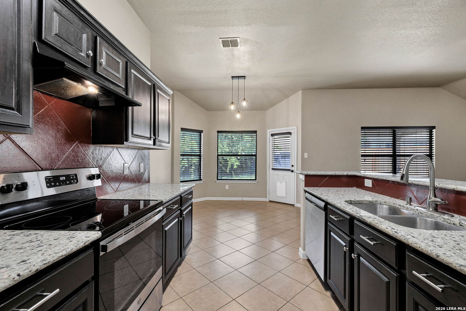 4015 Shervin Way Converse, TX 78109 - Photo 18 of 43 a kitchen with stainless steel appliances granite countertop a sink and a stove