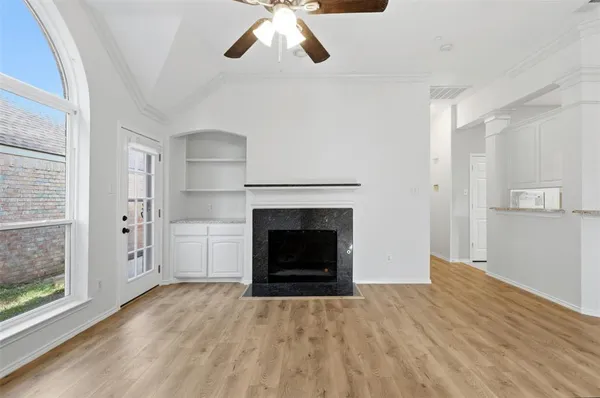 a view of a livingroom with a fireplace and window