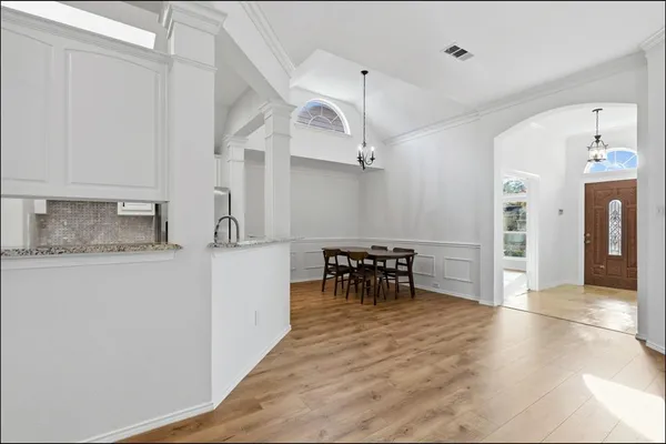 a view of dining room with kitchen island stainless steel appliances a refrigerator and a counter top space