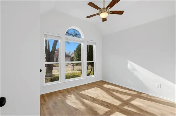 a view of a livingroom with a ceiling fan and window