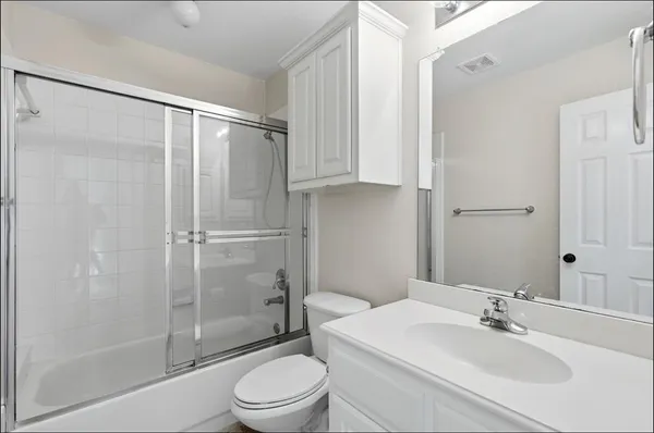 a bathroom with a shower a toilet and a sink