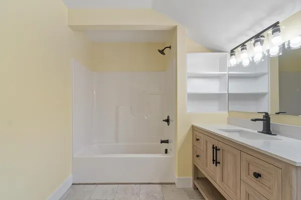 a bathroom with a tub sink and a mirror