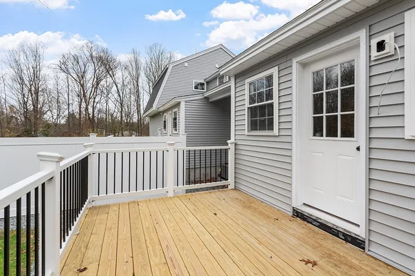 a view of a house with a wooden fence