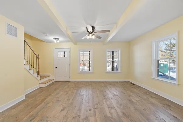 wooden floor in an empty room with a window
