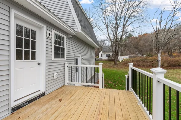 a view of a house with backyard and deck