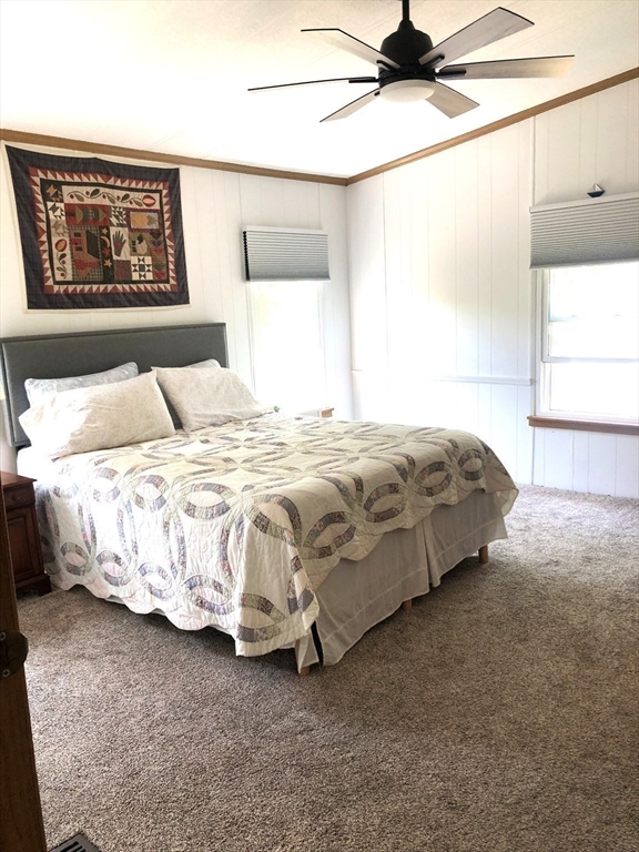 41 Pipers Way Carver, MA 02330 - Photo 17 of 36 a bedroom with a bed and a painting on the wall