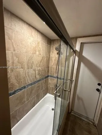 a bathroom with a shower and a tub