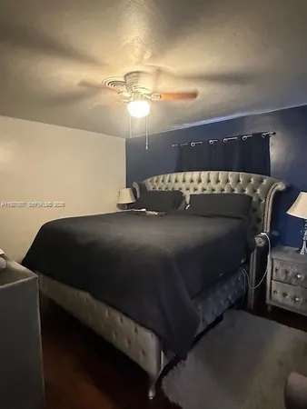 a bed sitting in a bedroom next to a lamp