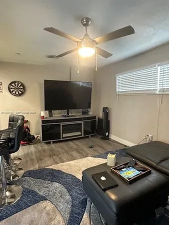 a bedroom with furniture and a flat screen tv