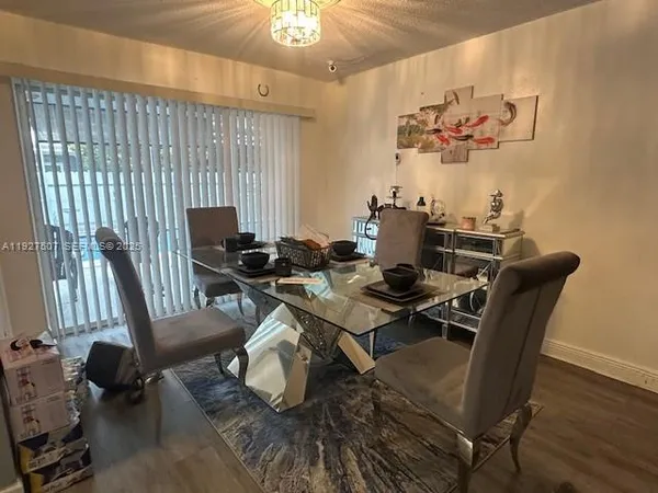 a view of a dining room with furniture wooden floor and chandelier