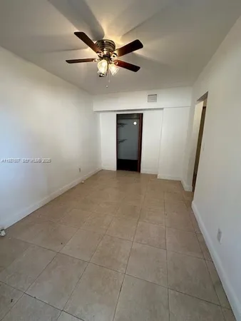 a view of a livingroom with a ceiling fan and window