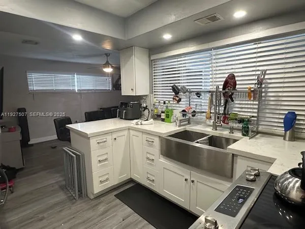 a kitchen with a sink and wooden cabinets