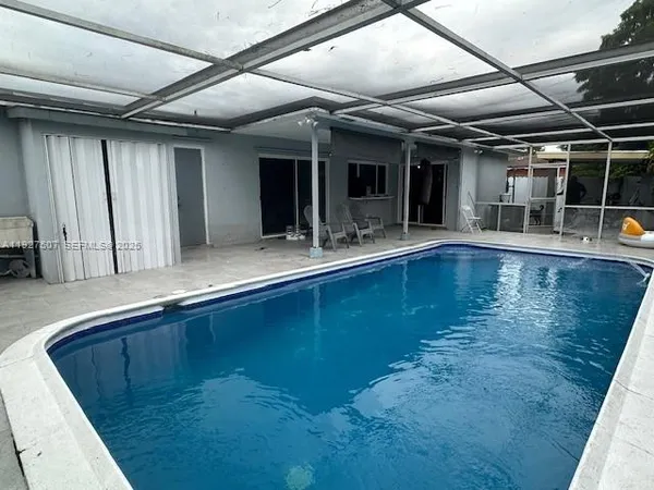 a view of swimming pool with outdoor seating