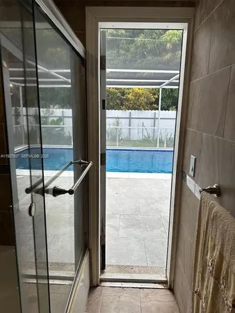 a bathroom with a glass shower door