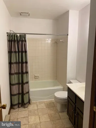 a bathroom with a toilet a sink and a shower