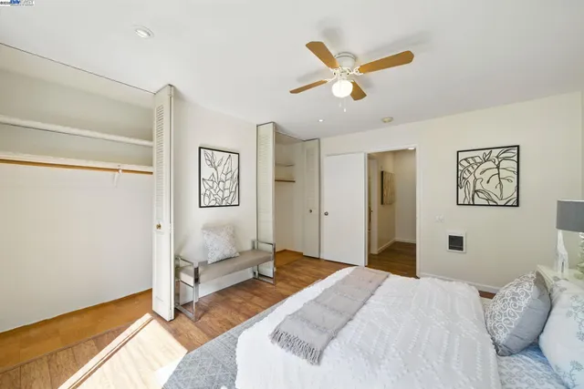 a bedroom with a large bed chandelier and a window