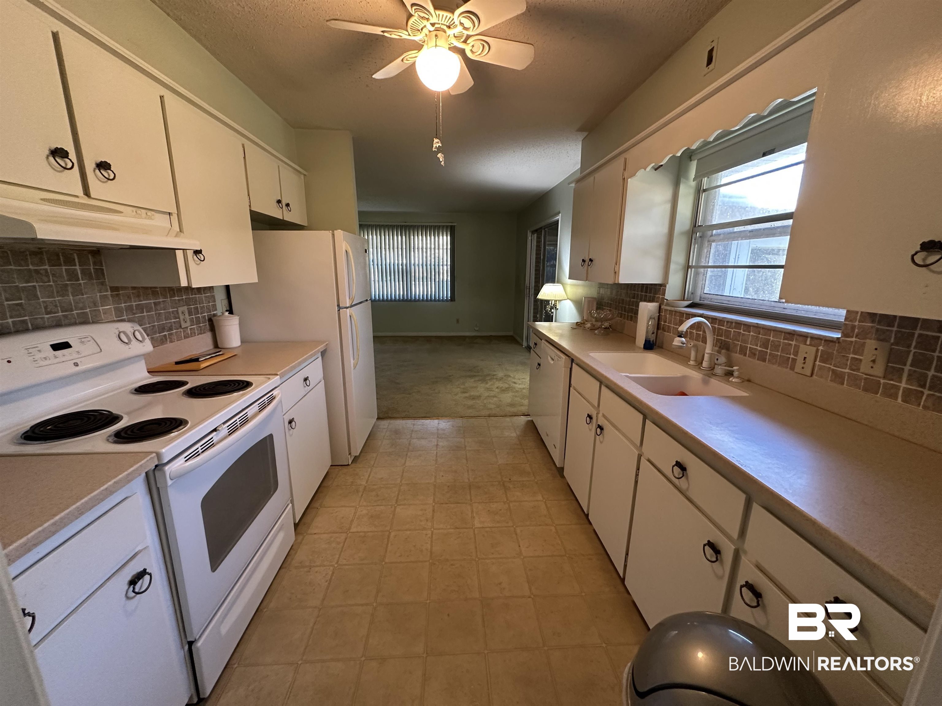 1 Yupon Circle Foley, AL 36535 - Photo 23 of 30 Kitchen with white appliances, light countertops, tasteful backsplash, a ceiling fan, and white cabinetry