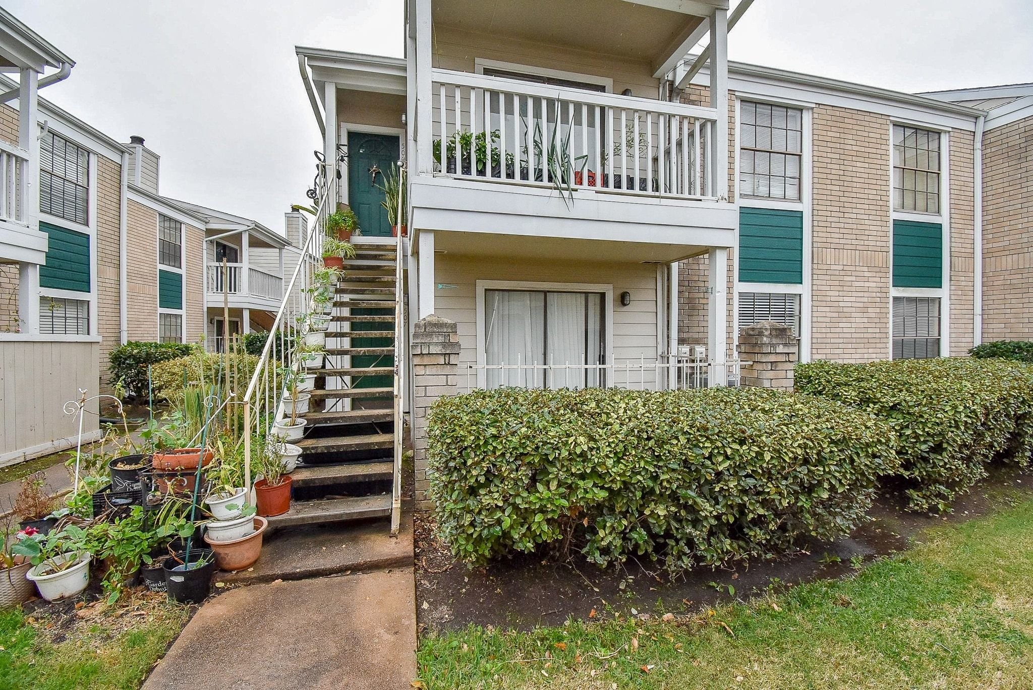 12660 Ashford Point Drive, Unit 507 Houston, TX 77082 - Photo 1 of 28 front view of a house with a small yard