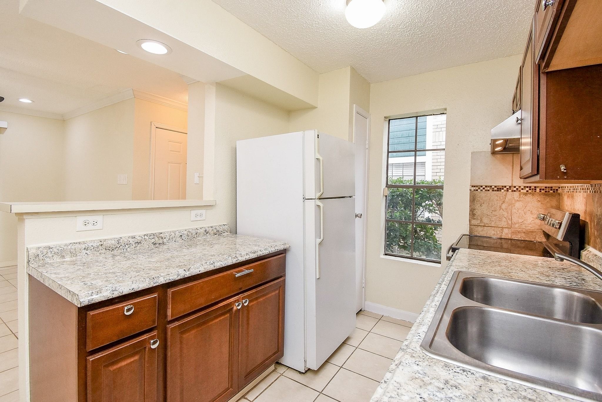 12660 Ashford Point Drive, Unit 507 Houston, TX 77082 - Photo 12 of 28 a kitchen with stainless steel appliances granite countertop a sink stove and refrigerator