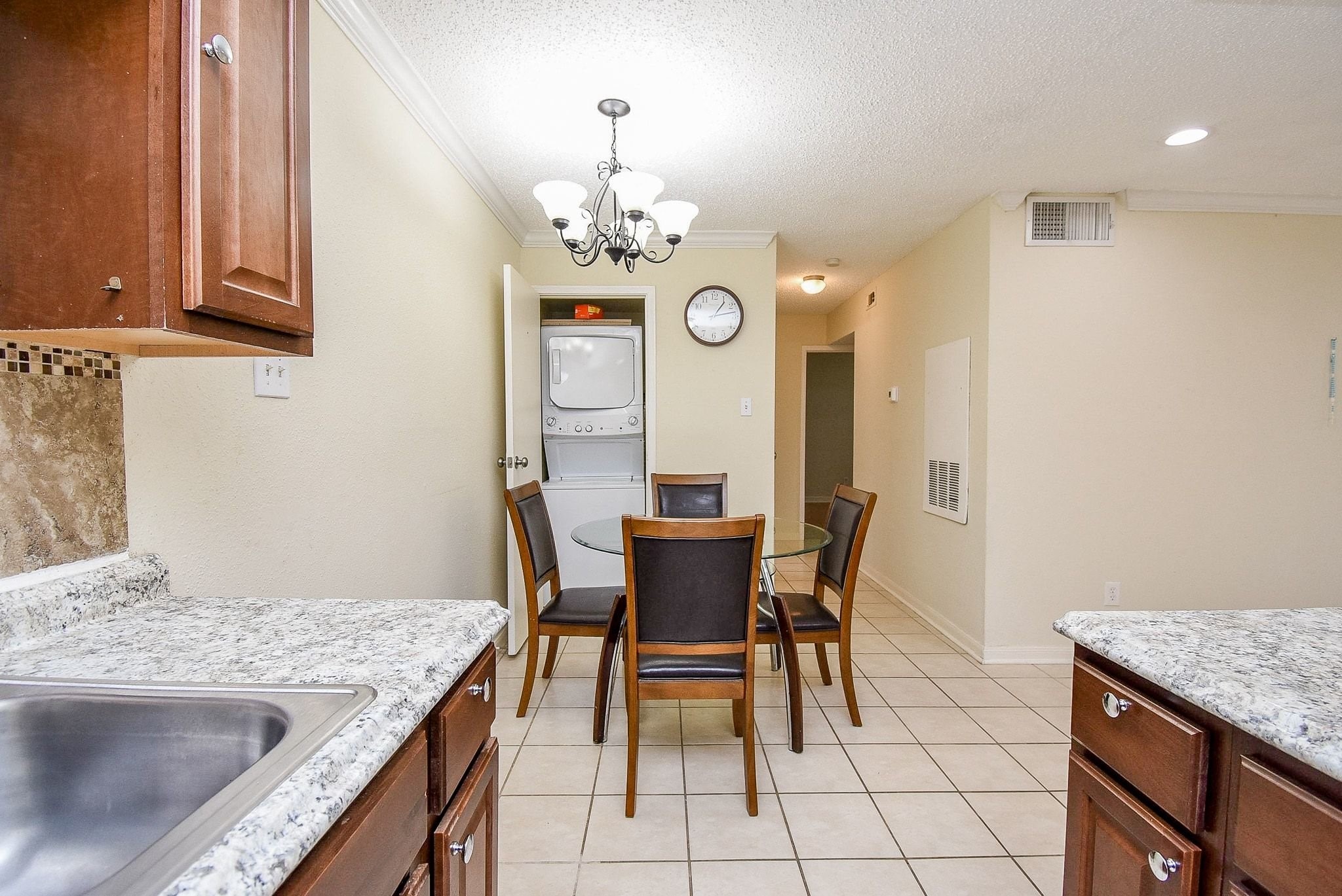12660 Ashford Point Drive, Unit 507 Houston, TX 77082 - Photo 14 of 28 a view of a dining room with furniture and chandelier