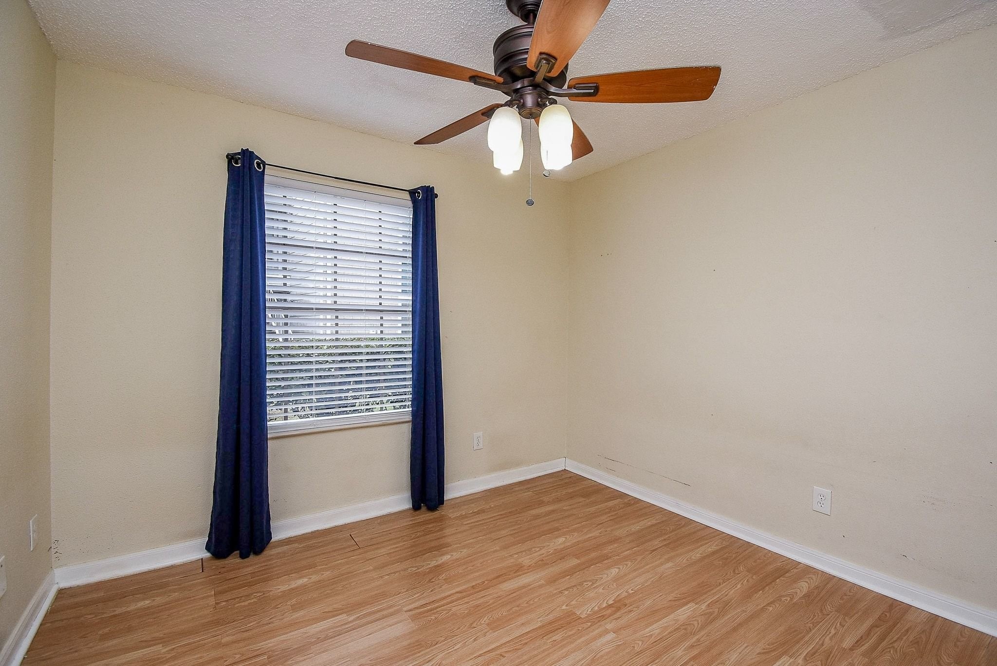 12660 Ashford Point Drive, Unit 507 Houston, TX 77082 - Photo 18 of 28 wooden floor in an empty room with a window