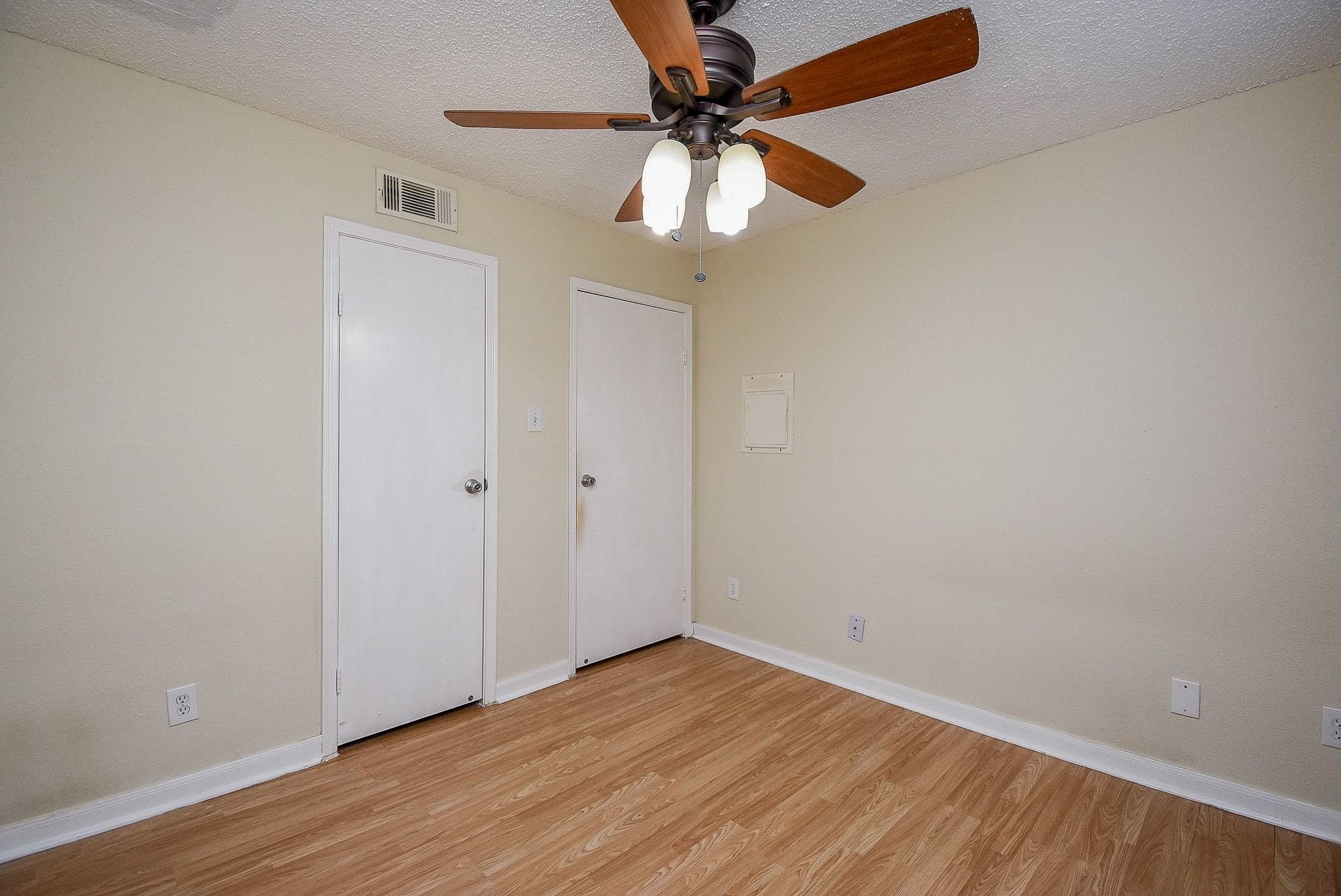 12660 Ashford Point Drive, Unit 507 Houston, TX 77082 - Photo 19 of 28 an empty room with wooden floor fan and windows