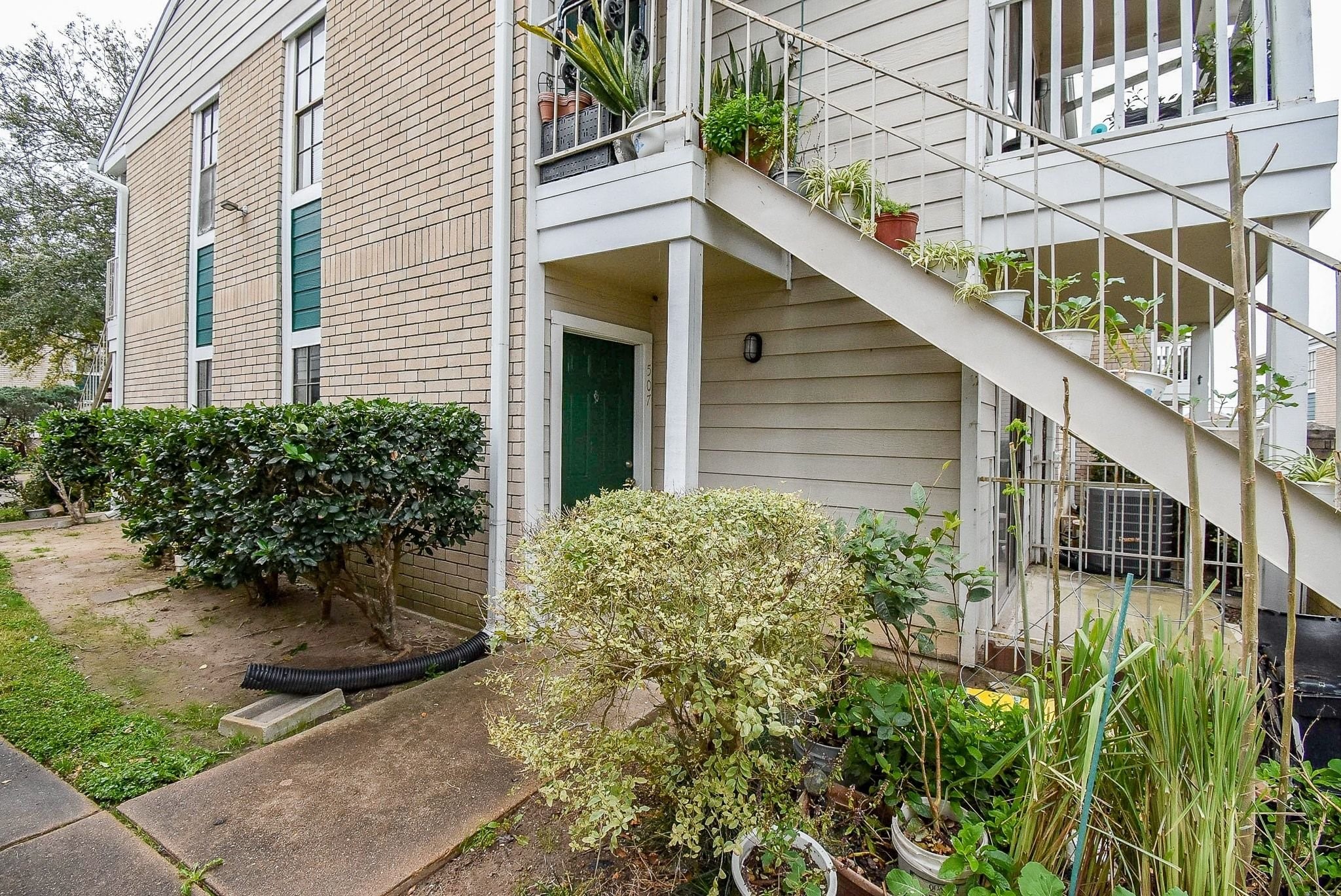 12660 Ashford Point Drive, Unit 507 Houston, TX 77082 - Photo 3 of 28 a view of a house with brick walls and potted plants