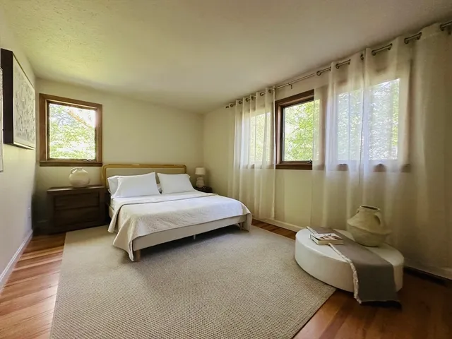 a bedroom with a bed couch and a window