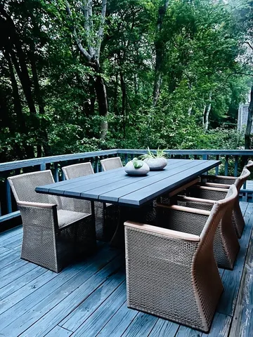 a view of outdoor sitting area with furniture and wooden floor