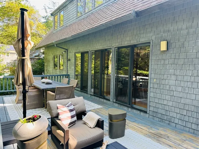 a view of a patio with couple of chairs and a table