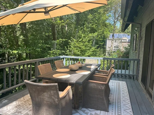 a view of a balcony with two chairs and a table