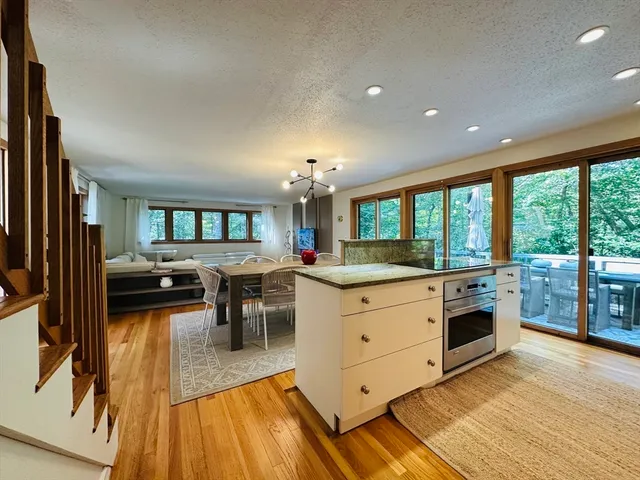 a open kitchen with white cabinets and stainless steel appliances