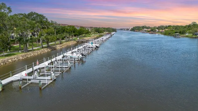 an aerial view of a residential house with outdoor space and a lake view