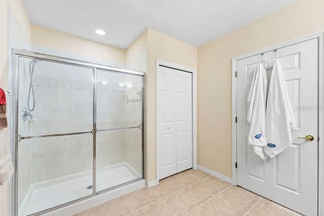 a living room with furniture a flat screen tv and a large window